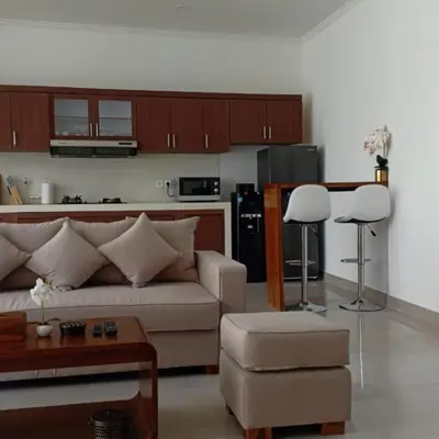 a living room with a couch and a kitchen at Villa Akmali Seminyak Basangkasa- 2 Bedrooms in Seminyak