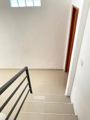 a staircase in a white room with a window at Villa Akmali Seminyak Basangkasa- 2 Bedrooms in Seminyak