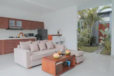 a living room with a white couch and a table at Villa Akmali Seminyak Basangkasa- 2 Bedrooms in Seminyak