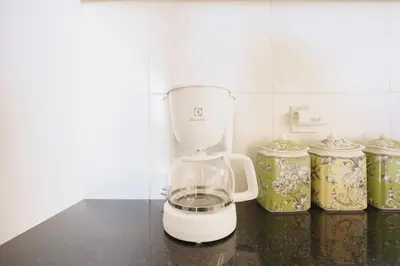 a white blender sitting on a counter next to jars at Villa Orked 3 with family room Seminyak in Seminyak