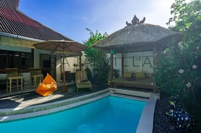 a villa with a swimming pool and a hut at Villa Kainara Seminyak by RPM in Seminyak