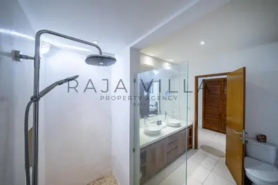 a bathroom with two sinks and a shower at Villa Kainara Seminyak by RPM in Seminyak