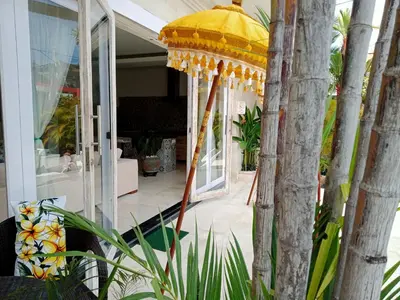 a yellow umbrella in front of a house at Villa Filo's Paradise Pool n Spa. Seminyak in Seminyak
