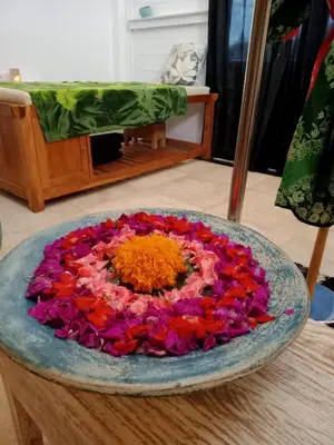 a large bowl filled with flowers on a table at Villa Filo's Paradise Pool n Spa. Seminyak in Seminyak