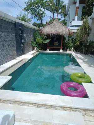 a swimming pool with a swimming hoop in front of a house at Villa Filo's Paradise Pool n Spa. Seminyak in Seminyak