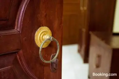 a wooden door with a lock on it at Segara Sadhu Inn Kuta by ecommerceloka in Kuta