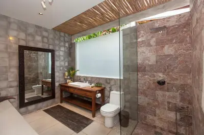 a bathroom with a toilet and a sink and a shower at Villa Liang by Nagisa Bali in Seminyak