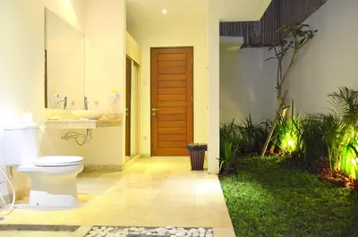 a bathroom with a toilet and a sink at Jas Green Villas and Spa in Seminyak