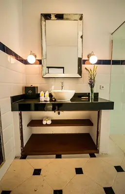 a bathroom with a sink and a mirror at The Indies Estate in Sanur
