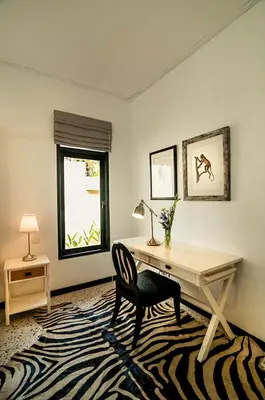 a office with a desk and a chair and a window at The Indies Estate in Sanur