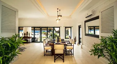 a dining room with a table and some chairs at The Indies Estate in Sanur
