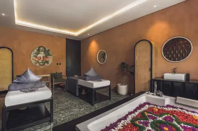 a hotel room with a bath tub and a sink at Monolocale Resort & Spa Seminyak by Ini Vie Hospitality in Seminyak