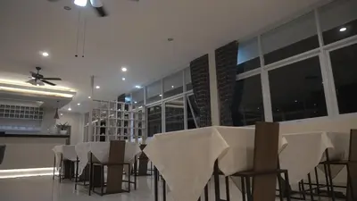 a dining room with a table with white table cloth at Ultimate Residence Bali in Denpasar