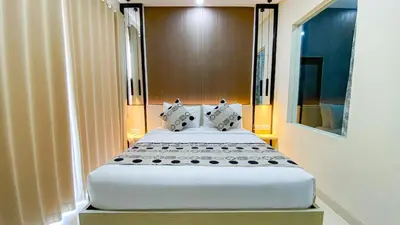 two beds in a hotel room with two beds at Ultimate Residence Bali in Denpasar