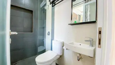 a bathroom with a toilet and a sink and a shower at Ultimate Residence Bali in Denpasar
