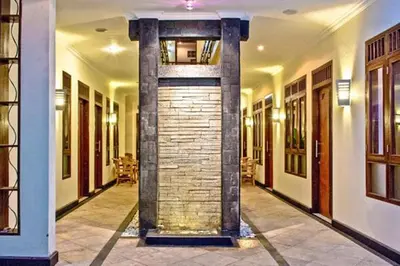 a hallway with a brick pillar in a building at Kuta EcoStay in Kuta