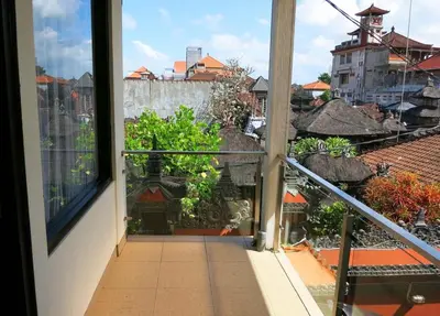 a balcony with a view of a building at Kuta EcoStay in Kuta