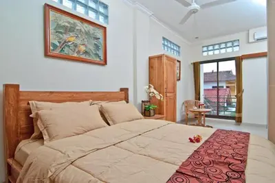 a bedroom with a large bed in a room at Kuta EcoStay in Kuta