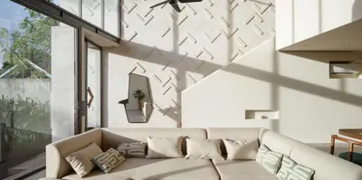 a living room with a couch and a large window at ASAI Village in Jimbaran