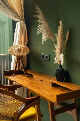a wooden table with a chair and a vase on it at ASAI Village in Jimbaran