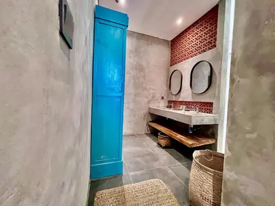 a bathroom with a blue door and a sink at Rumah Hadeka Petitenget in Seminyak