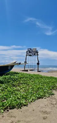 a boat on the beach with a bench in the background at Rumah Hadeka Petitenget in Seminyak