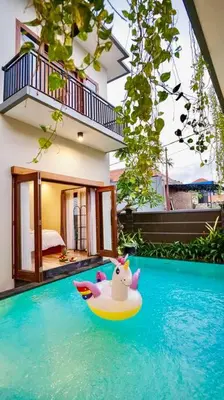 a toy unicorn on a raft in a swimming pool at Villa Cleopatra Bali in Sanur