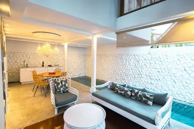 a living room with a couch and a table at Calm Villa in Seminyak