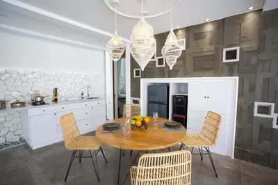a kitchen with a wooden table and chairs at Calm Villa in Seminyak