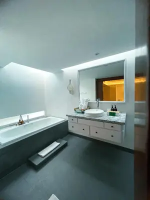 a bathroom with a tub and a sink and a mirror at Calm Villa in Seminyak