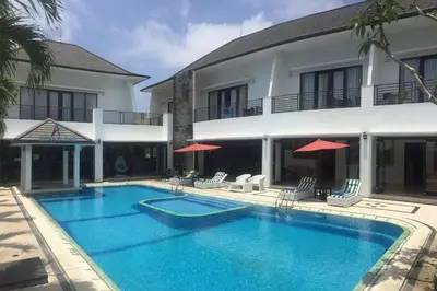 a swimming pool in front of a building at Aldeoz Villa Nusa Dua in Nusa Dua