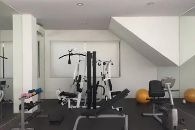 a gym with several exercise equipment in a room at Aldeoz Villa Nusa Dua in Nusa Dua