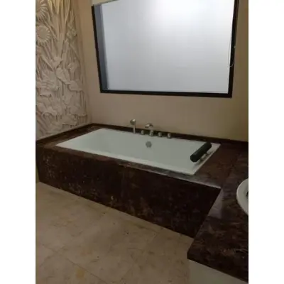 a bath tub in a bathroom with a large mirror at Aldeoz Villa Nusa Dua in Nusa Dua