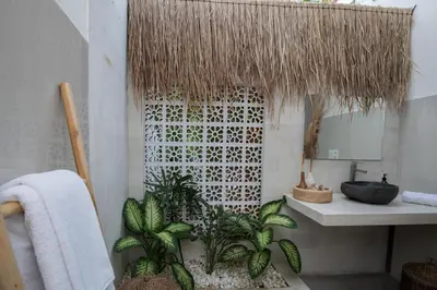 a bathroom with a sink and some plants in it at Villa Luna Rose in Seminyak