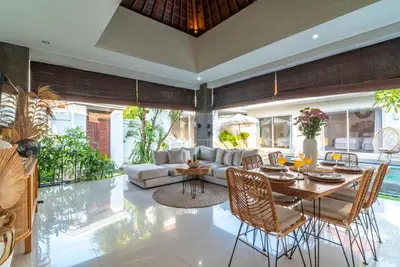 a living room with a couch and a table at Villa Luna Rose in Seminyak
