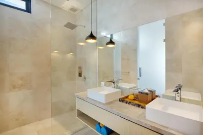 a bathroom with two sinks and a mirror at Eight Palms Villa Seminyak by Ini Vie Hospitality in Seminyak