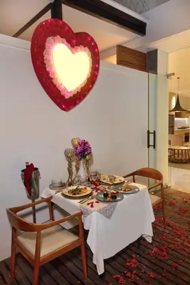 a table with a heart hanging on a wall at Eight Palms Villa Seminyak by Ini Vie Hospitality in Seminyak