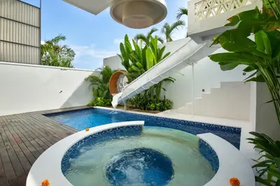 a hot tub in the backyard of a house at Eight Palms Villa Seminyak by Ini Vie Hospitality in Seminyak