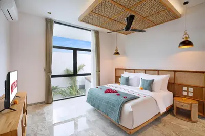 a bedroom with a bed and a large window at Eight Palms Villa Seminyak by Ini Vie Hospitality in Seminyak