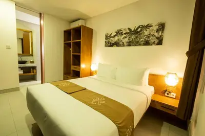 a bedroom with a large bed in a room at THE COINS VILLA SEMINYAK in Seminyak