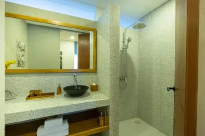 a bathroom with a sink and a mirror at THE COINS VILLA SEMINYAK in Seminyak