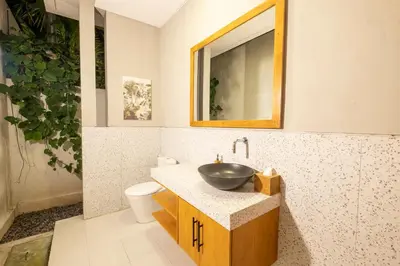 a bathroom with a sink and a mirror at THE COINS VILLA SEMINYAK in Seminyak