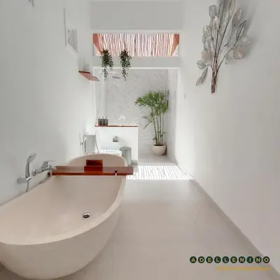 a white bathroom with a tub and potted plants at CASA LUWIH Newly Renovated 2BR Villa with Private Pool in Seminyak in Seminyak