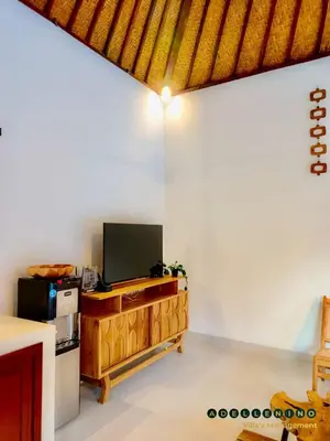 a living room with a television and a refrigerator at CASA LUWIH Newly Renovated 2BR Villa with Private Pool in Seminyak in Seminyak