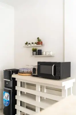 a microwave on a white table in a kitchen at Casa de Lupe 5 bedroom villa in Kerobokan in Seminyak
