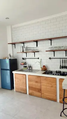 a kitchen with a sink and a stove and a refrigerator at Casa de Lupe 5 bedroom villa in Kerobokan in Seminyak