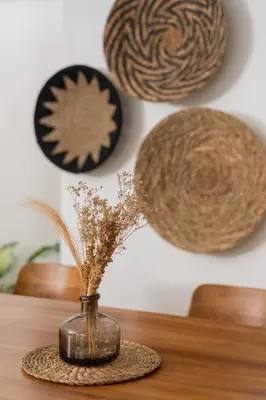 a vase with feathers in it sitting on a table at Casa de Lupe 5 bedroom villa in Kerobokan in Seminyak