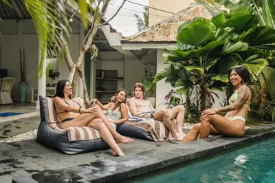 a group of women sitting around a swimming pool at Dreams Villa -Private Pool, Fast Wifi, 2 min to Double Six Beach in Seminyak