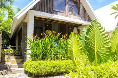 a house with plants in front of it at Chanteak Bali - Stone House 3 in Jimbaran
