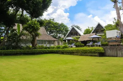 a large yard in front of a house at Chanteak Bali - Stone House 3 in Jimbaran